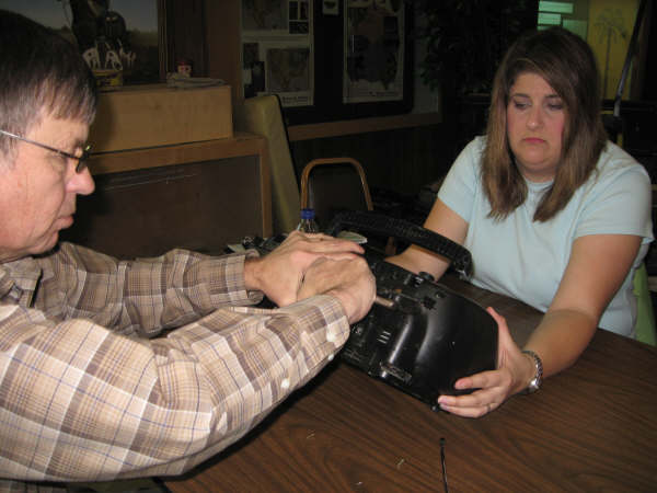 Picture of a man and woman taking apart a radio